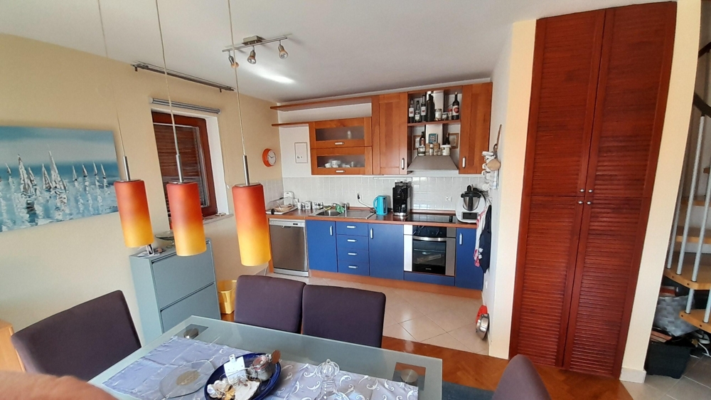 Kitchen with built-in appliances and storage space
