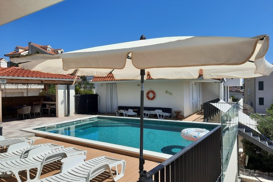 Pool area with sun terrace and loungers