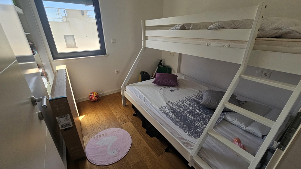 Children's room with bunk bed and window