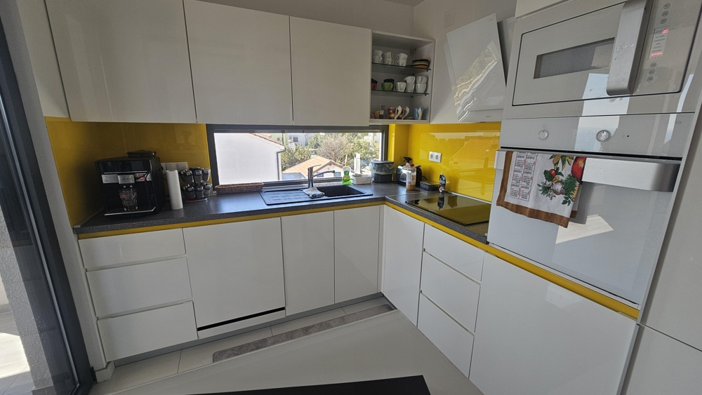 Modern kitchen with built-in appliances and window