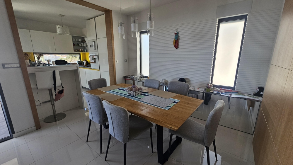 Dining area with table and access to the kitchen