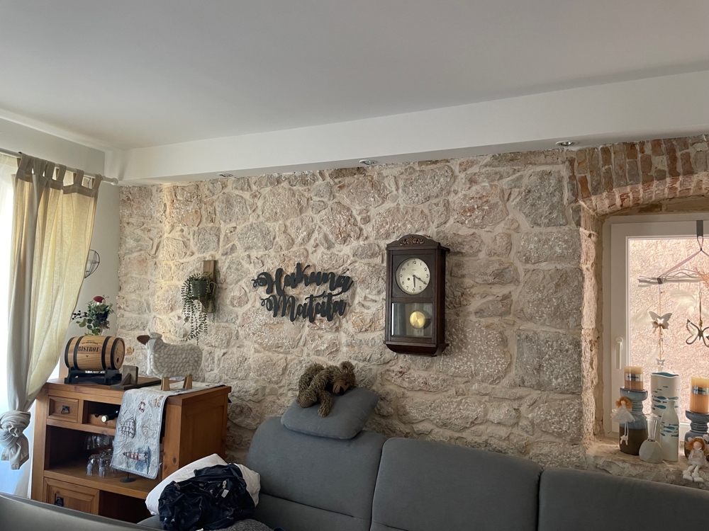 Living room with natural stone wall and decor