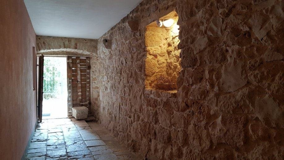 Hallway with natural stone wall and exit to the terrace