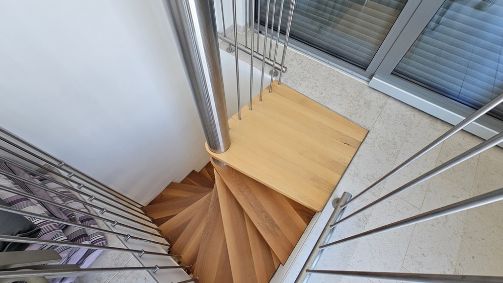 Interior staircase with wooden steps and modern railing