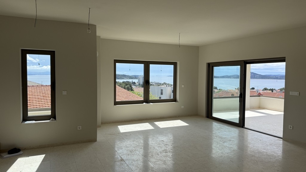 Spacious living room with panoramic windows and sea views