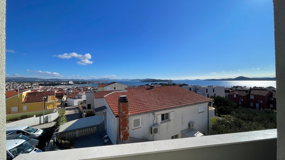 Sea views from the balcony over the rooftops and the coast