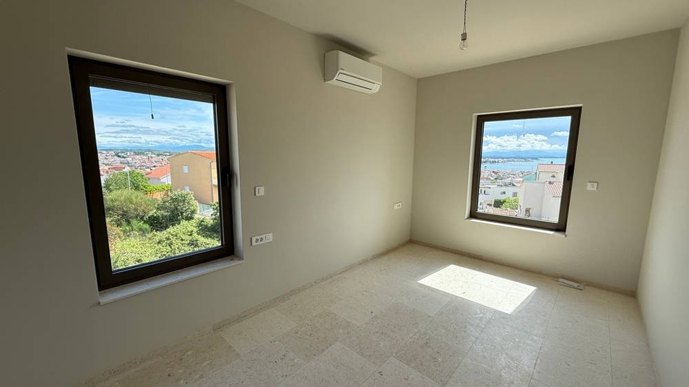 Bedroom with windows and air conditioning