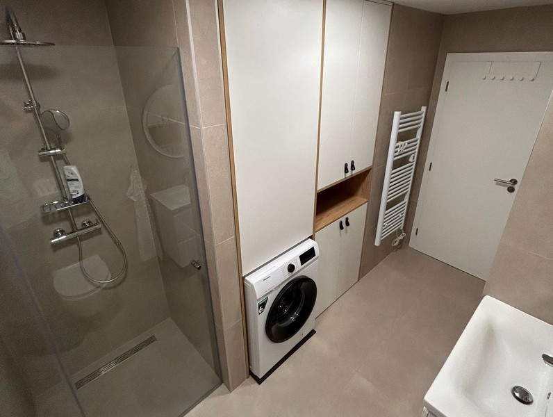 Bathroom with shower, washing machine and built-in wardrobe