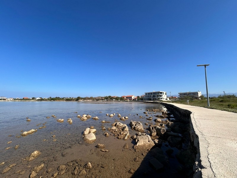 Coastline with promenade and clear sea in Privlaka