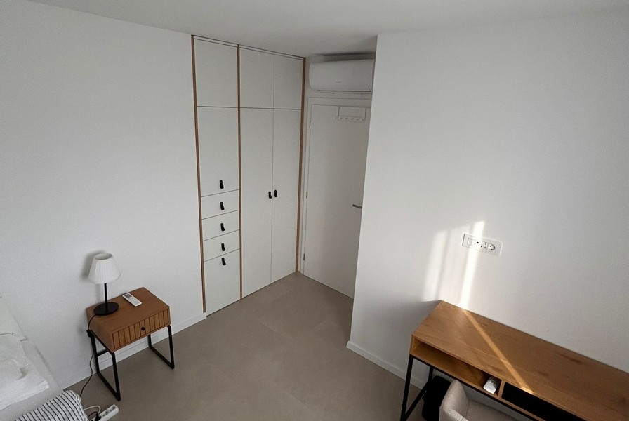 Bedroom with built-in wardrobe and natural light