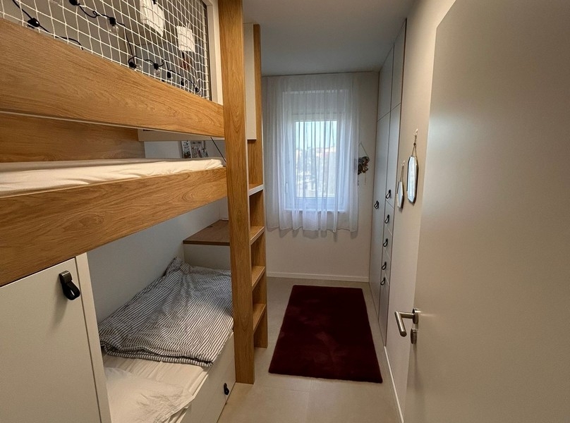Children's room with bunk bed and built-in wardrobes