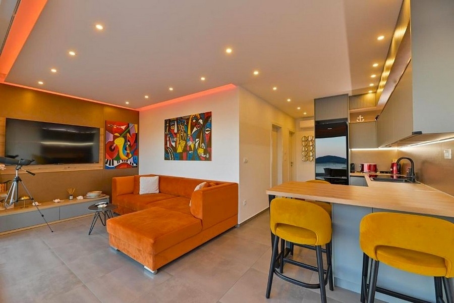 Living room with open kitchen and sea views
