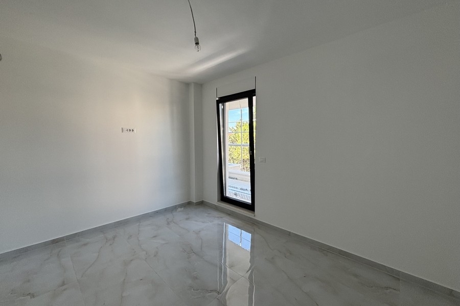 Bedroom with window and light tiled floor