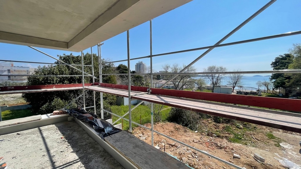 Balcony with scaffolding and sea view in Dalmatia.