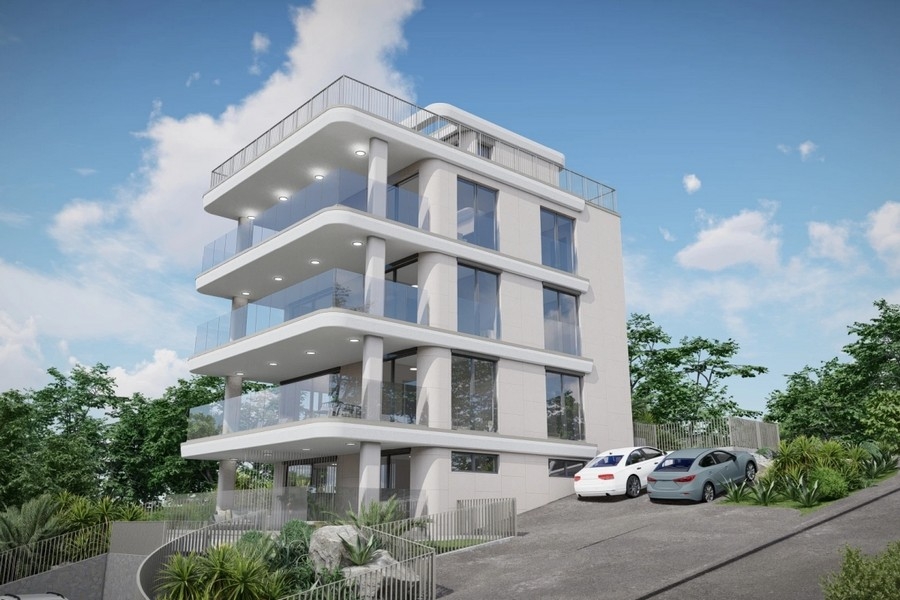 New building with spacious balconies and glass railings on a hillside