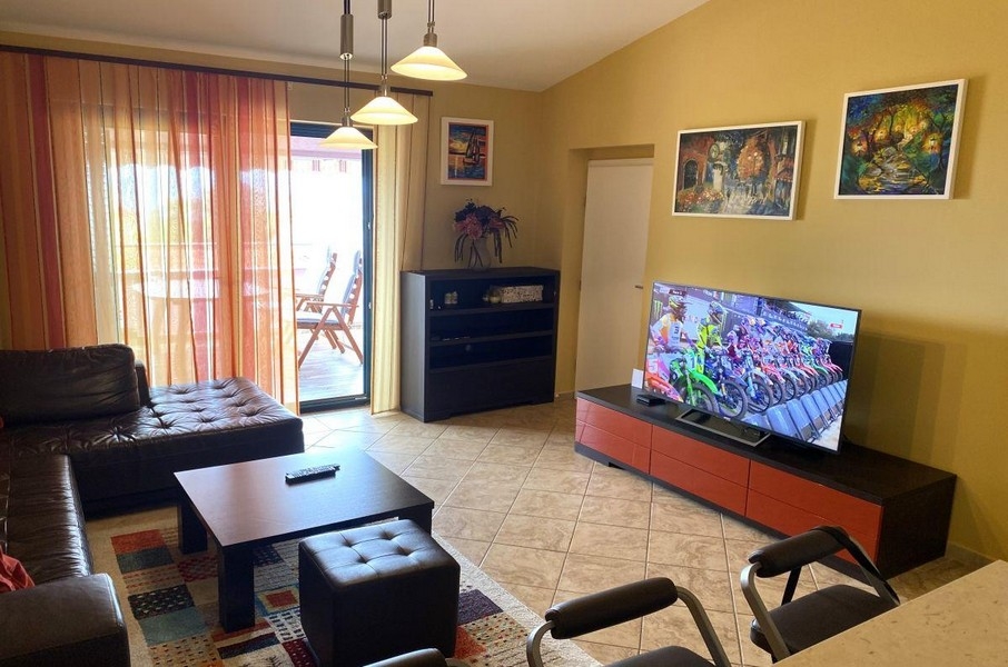 Living area with sofa and balcony access in holiday apartment on Krk