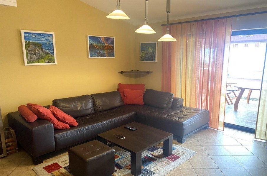 Bright living area with balcony and seating area in Malinska