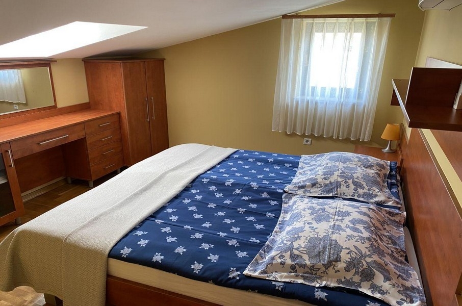 Bedroom with double bed and skylight in apartment on Krk