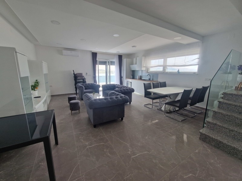 Modern living area with kitchen and sea views