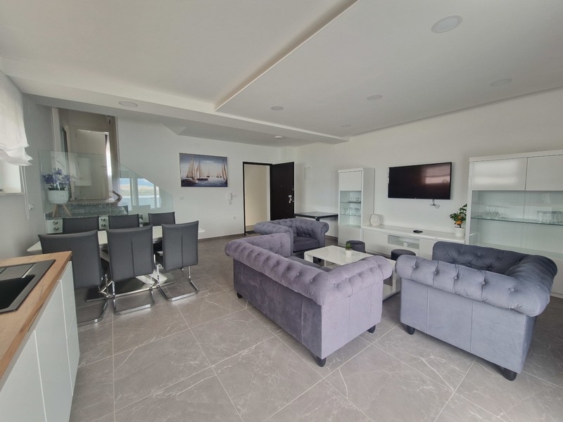 Bright living room with seating area and open kitchen