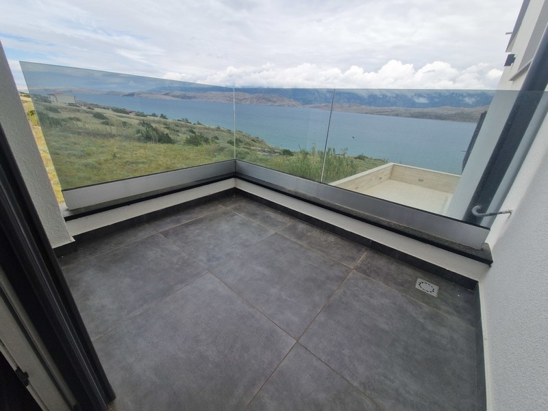 Covered terrace with glass railings and sea views