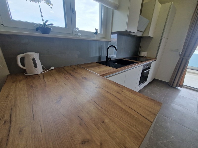 Modern fitted kitchen with work surface and sea views