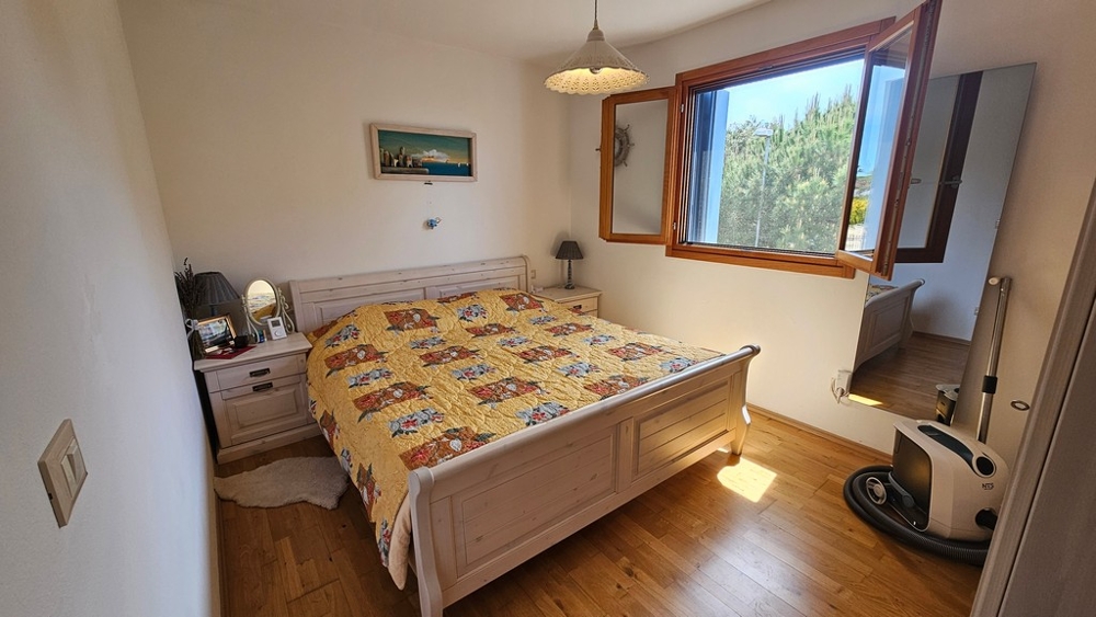 Bedroom with wooden parquet and window