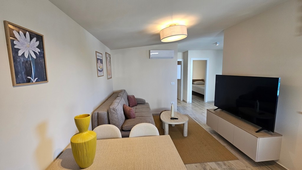Living room with TV and open kitchen area