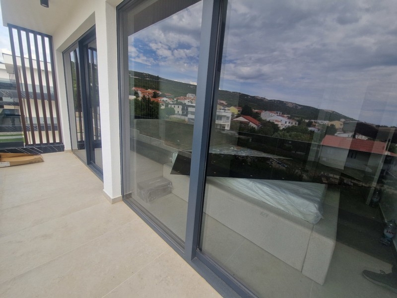 Covered terrace with glass railings and sea views
