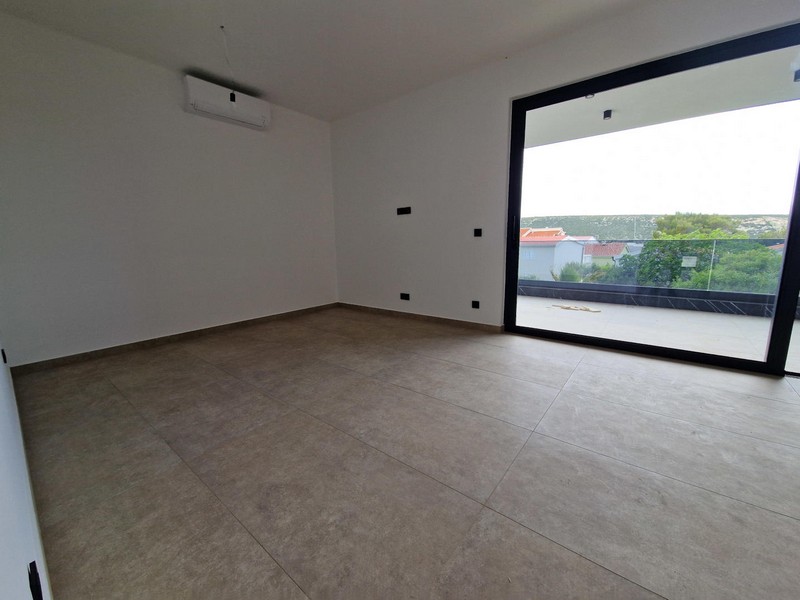Air-conditioned living room and view of the glass-fronted terrace.