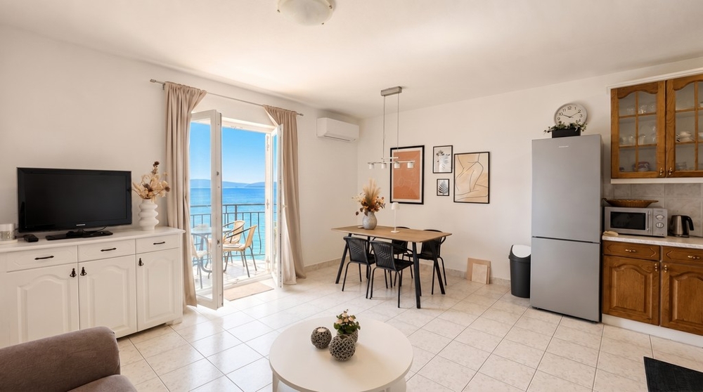 Open plan living and dining area with sea views