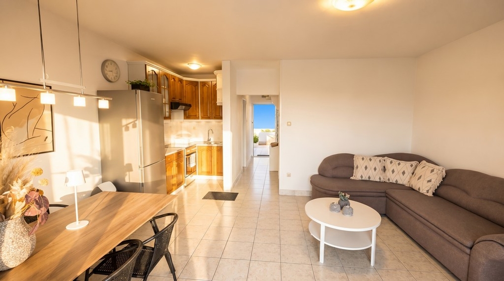 Living room with kitchen and access to the balcony