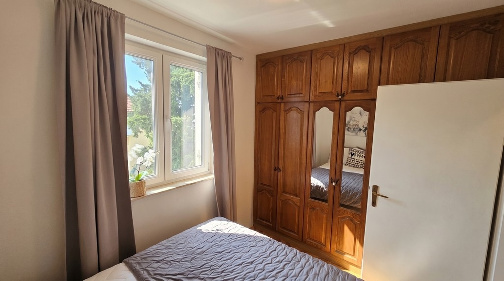 Bedroom with built-in wardrobe and natural light