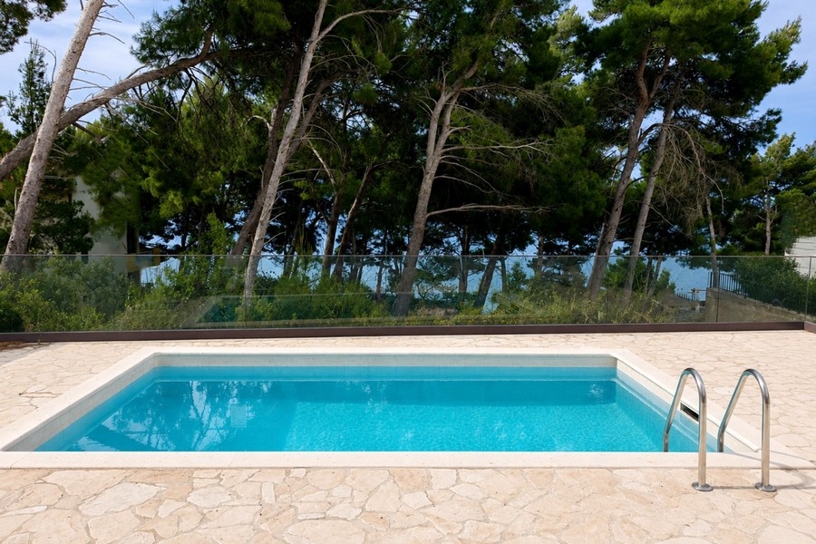 Swimming pool with terrace and Mediterranean gardens by the sea