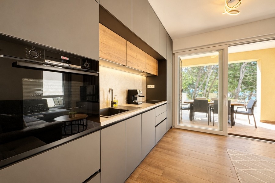 Open kitchen with modern equipment and covered terrace