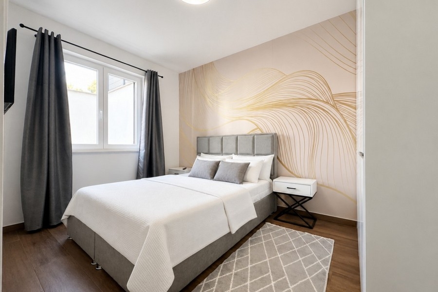 Modern bedroom with stylish wall design and TV