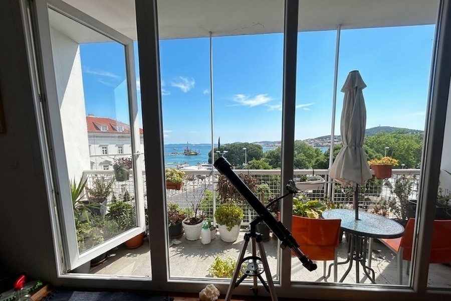 Living area with window front and sea view in Split