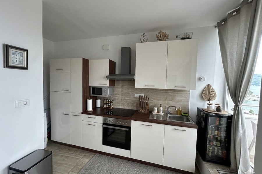 Modern kitchen with sea view in apartment