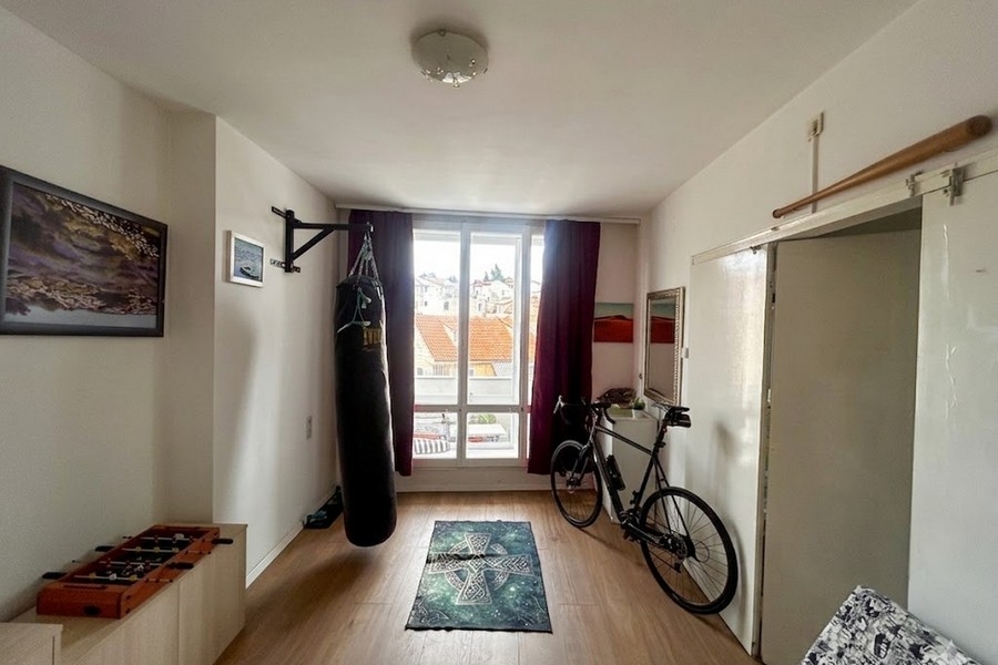 Bedroom with fitness area and city view