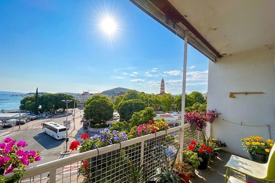 Terrace with flowers and view of the sea and old town of Split