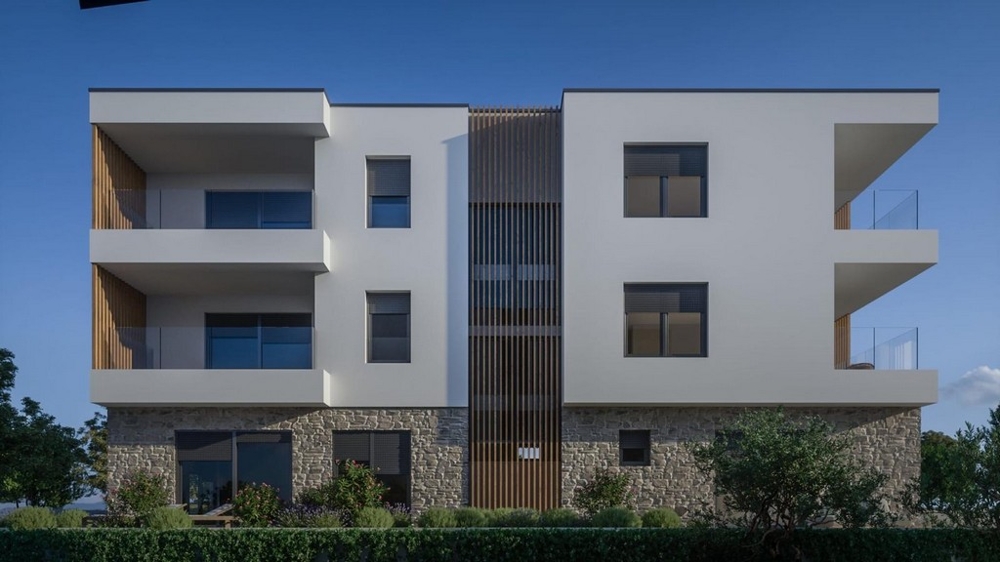 Modern apartment building with balconies and natural stone facade