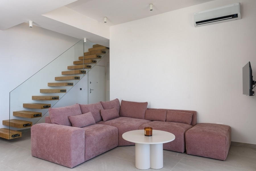 Bright living area with modern staircase