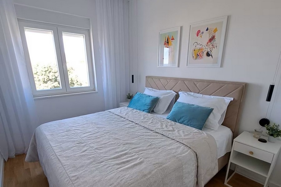 Modernly furnished bedroom with natural light