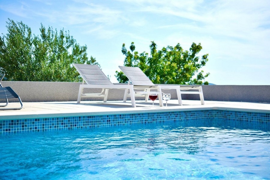 Swimming pool with outdoor sun loungers