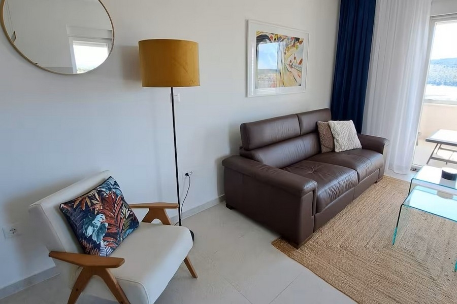 Bright living area with leather sofa and sea views