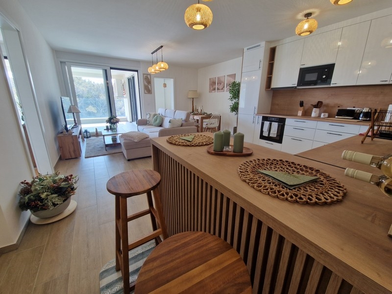Kitchen with cooking island and living area