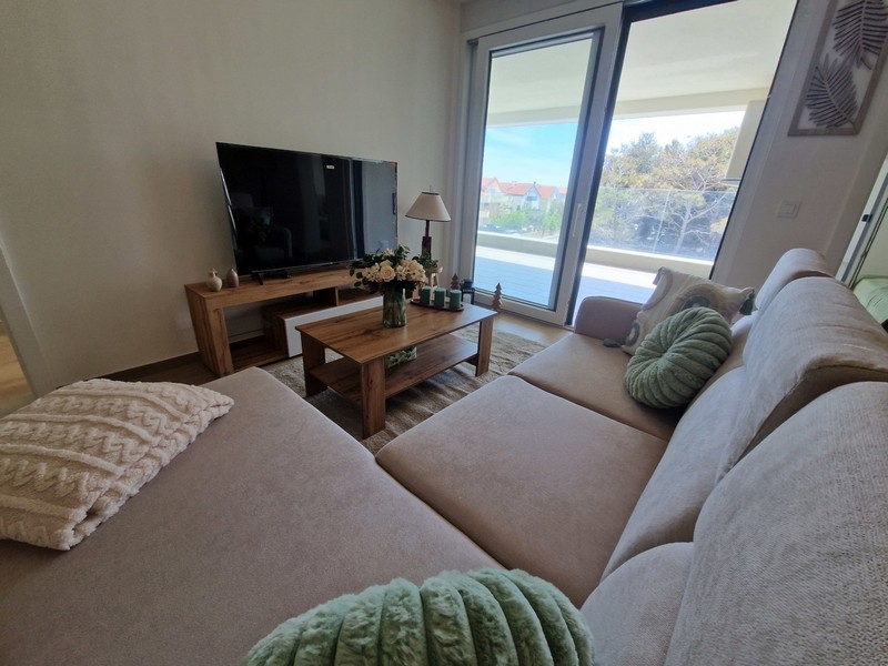 Living room with large window front and balcony access