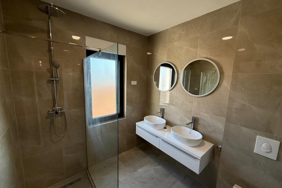 Bathroom with double sink and shower