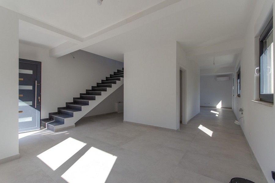 Bright living area with stairs and open floor plan