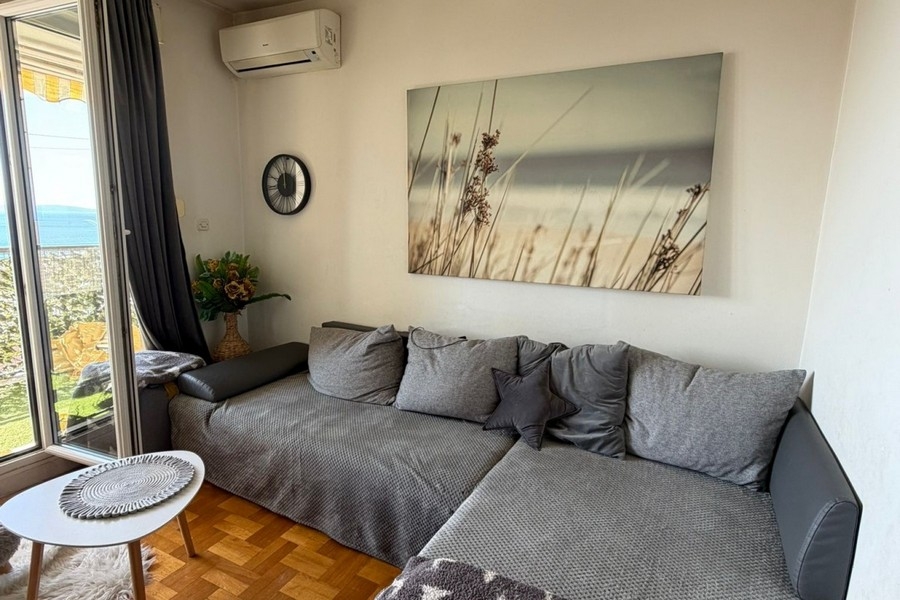 Living room with gray corner sofa and air conditioning